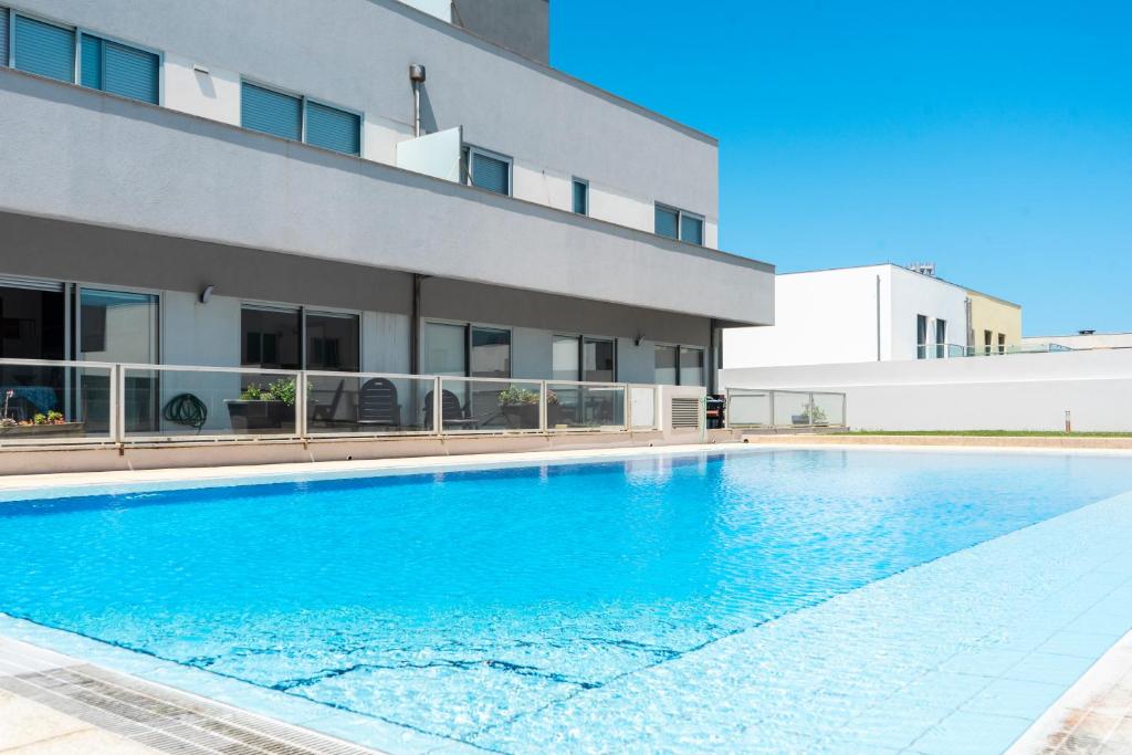 拉夫拉Oporto city and Beach apartment的大楼前的游泳池