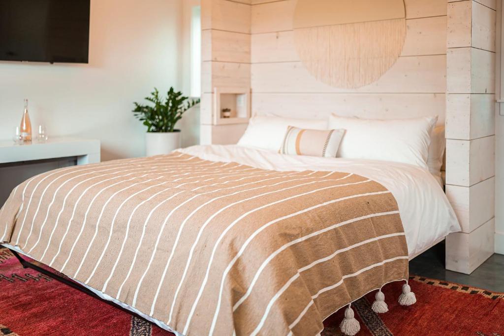 斯廷森海滩Funboard Room includes King Bed and Mini Kitchenette的一间卧室配有一张大床和木制床头板