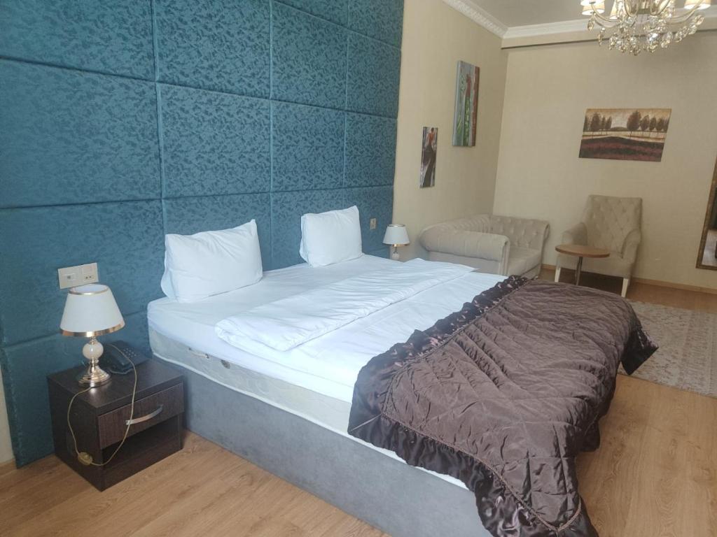 巴库Sherlock Gold Baku Hotel的一间卧室设有一张蓝色墙壁的大床