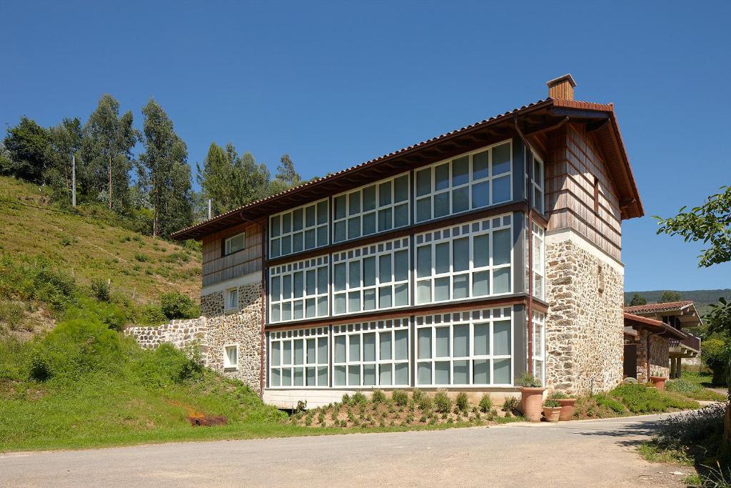 巴基奥Ureta Landa Gaztelugatxe的一座大建筑,在山边设有窗户