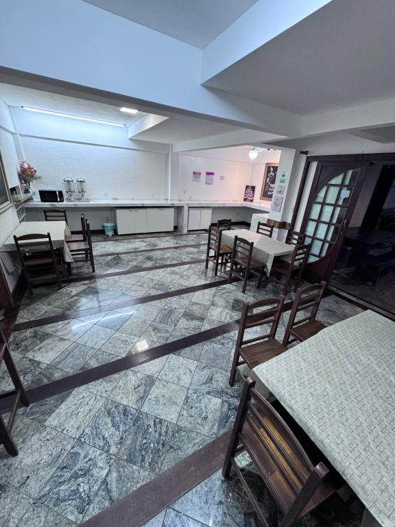 卡波布里奥Flamingo Beach Pousada的一间空房,配有桌椅,还有一间设有厨房的房间