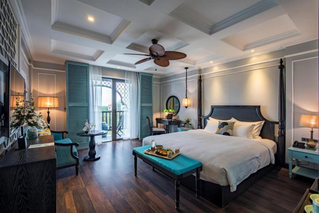 河内河内金月酒店的一间卧室配有一张床和吊扇