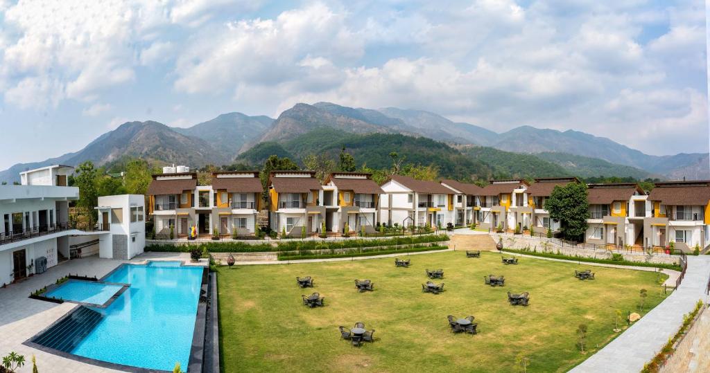兰纳加Evara Spa & Resort的一座带游泳池和山脉的度假村的形象