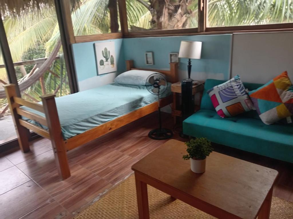 El Paredón Buena VistaEl Puente的一间卧室配有一张床、一张沙发和一张桌子