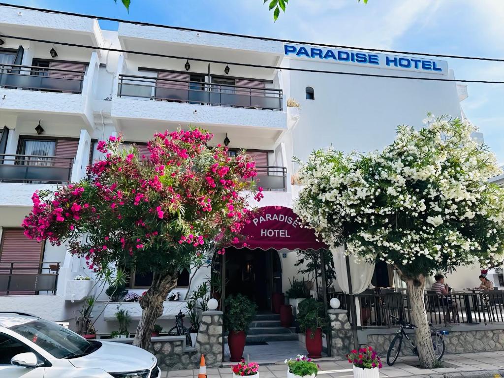 科斯镇Paradise Hotel的前面有开花树的酒店