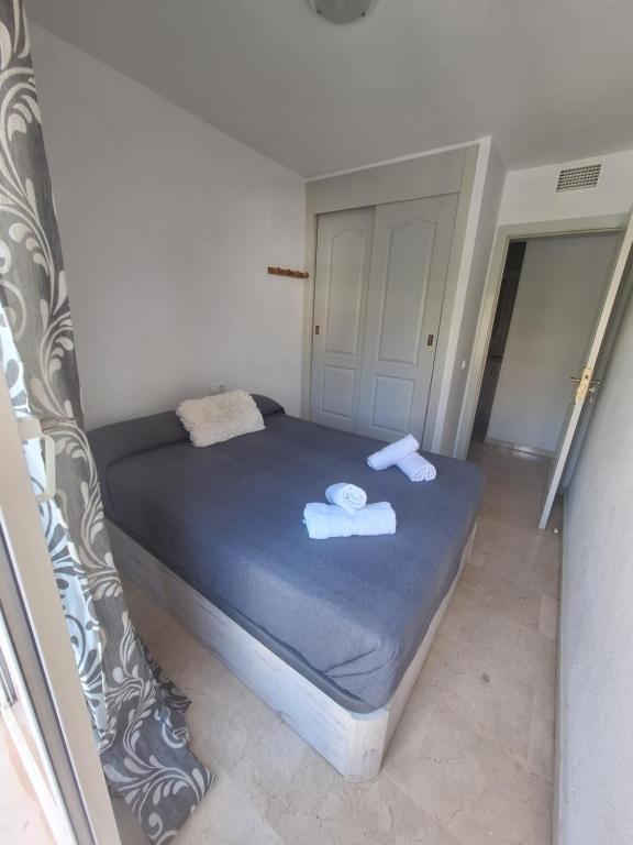 贝纳尔马德纳Apartamentos Jowi - Piso amplio y Familiar的一间小卧室,配有带毛巾的床