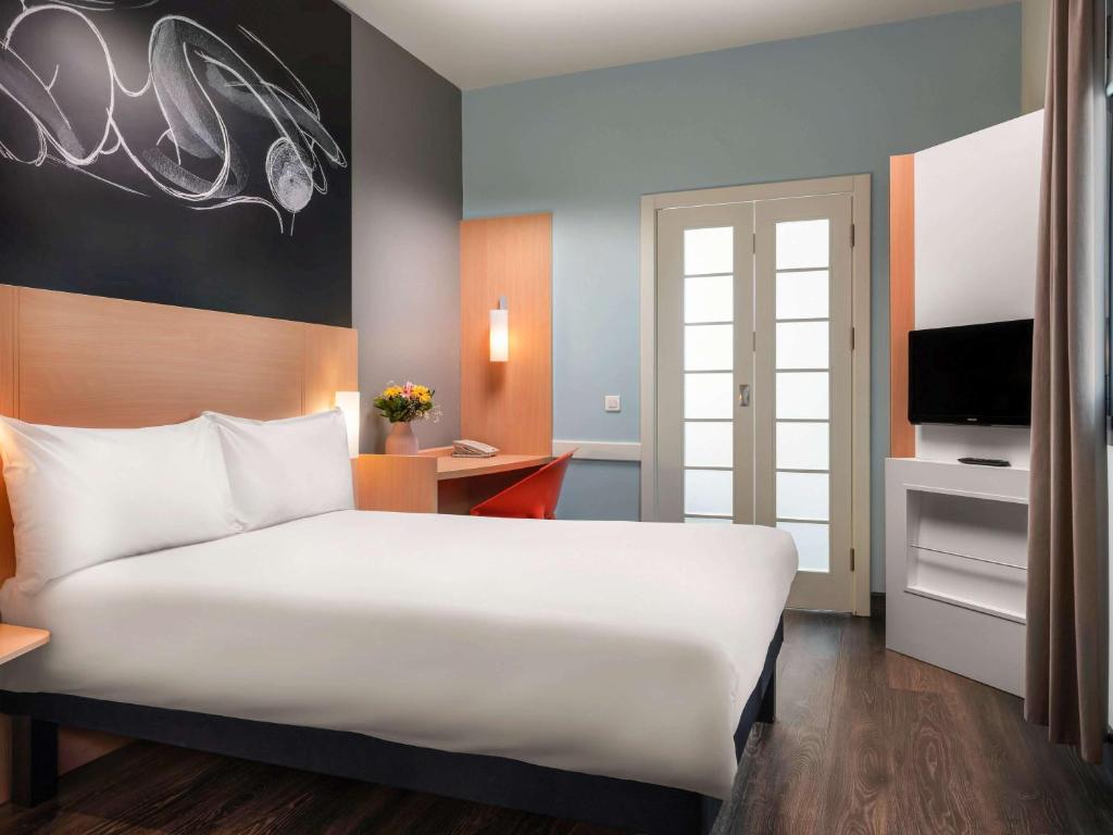 安卡拉宜必思安卡拉机场酒店的卧室配有一张白色大床和一张书桌