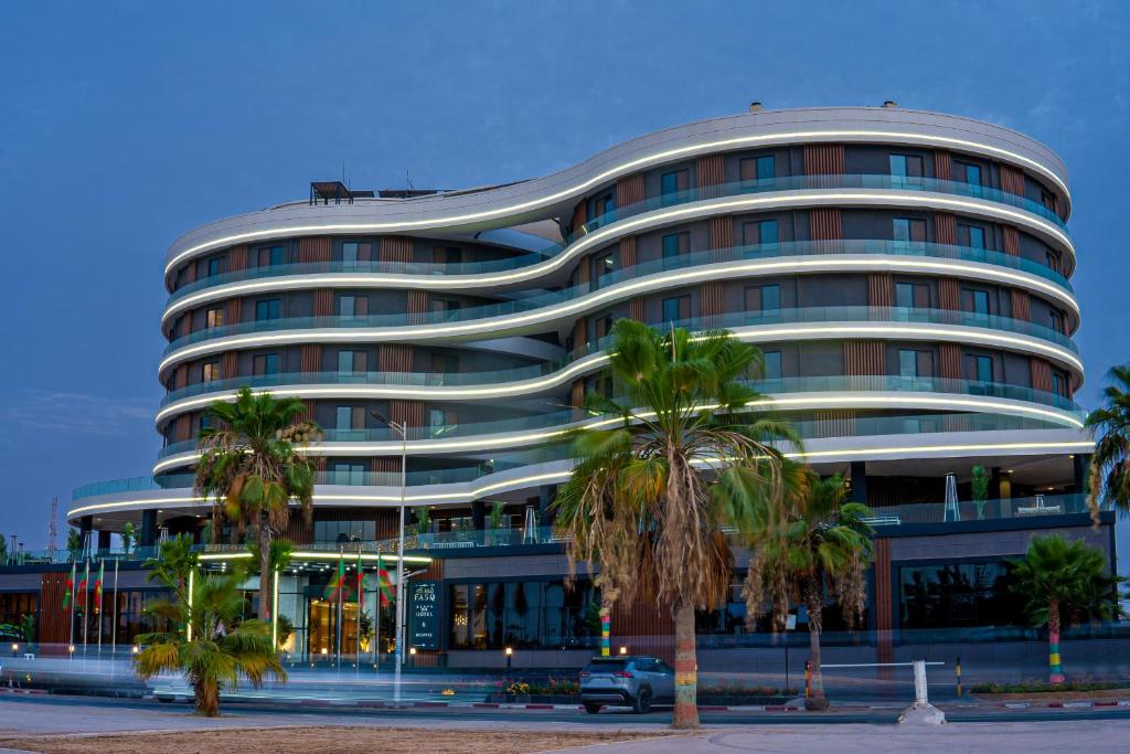 努瓦克肖特FASQ Hotel的一座棕榈树环绕的大建筑
