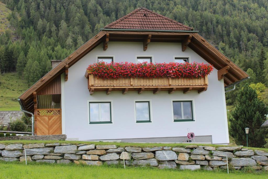 毛特恩多夫Gästehaus Maria Trattner的一座房子,阳台上装有红色的鲜花