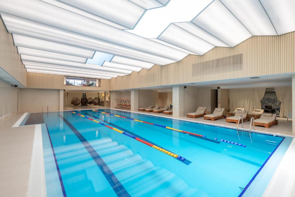 地拉那Spa & Pool - Studio Apartments 365的一个带大型天花板的室内游泳池