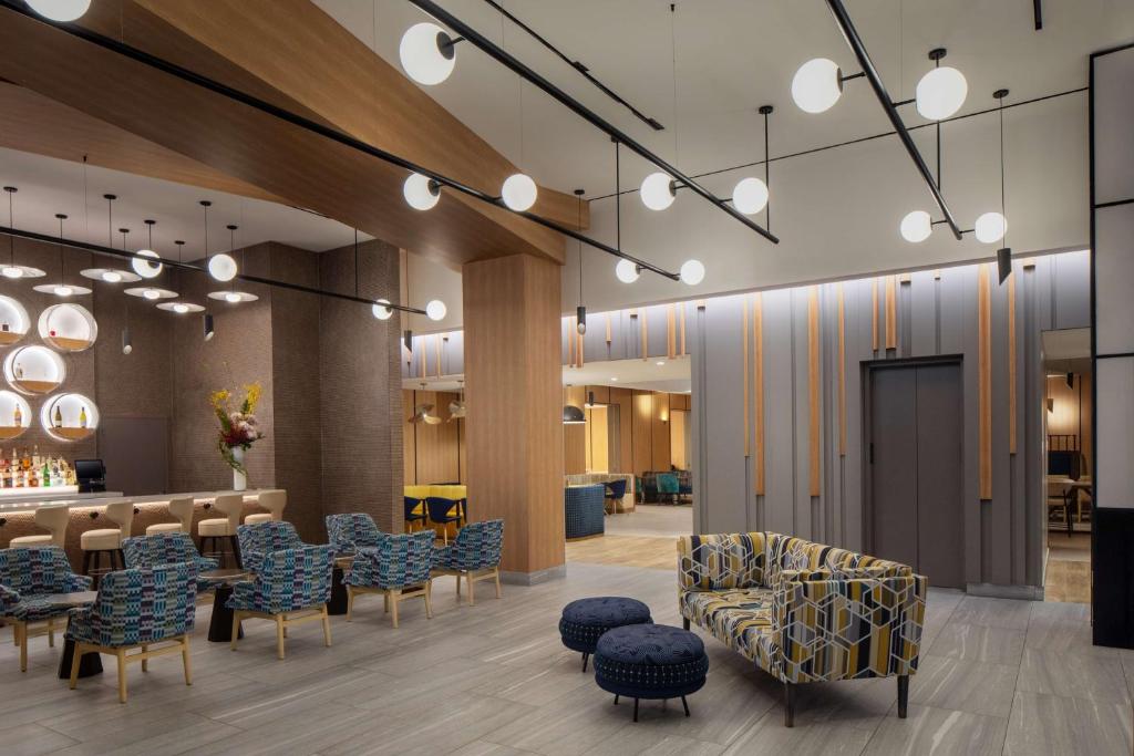 纽约Hampton Inn by Hilton New York Times Square的设有桌椅和酒吧的大厅