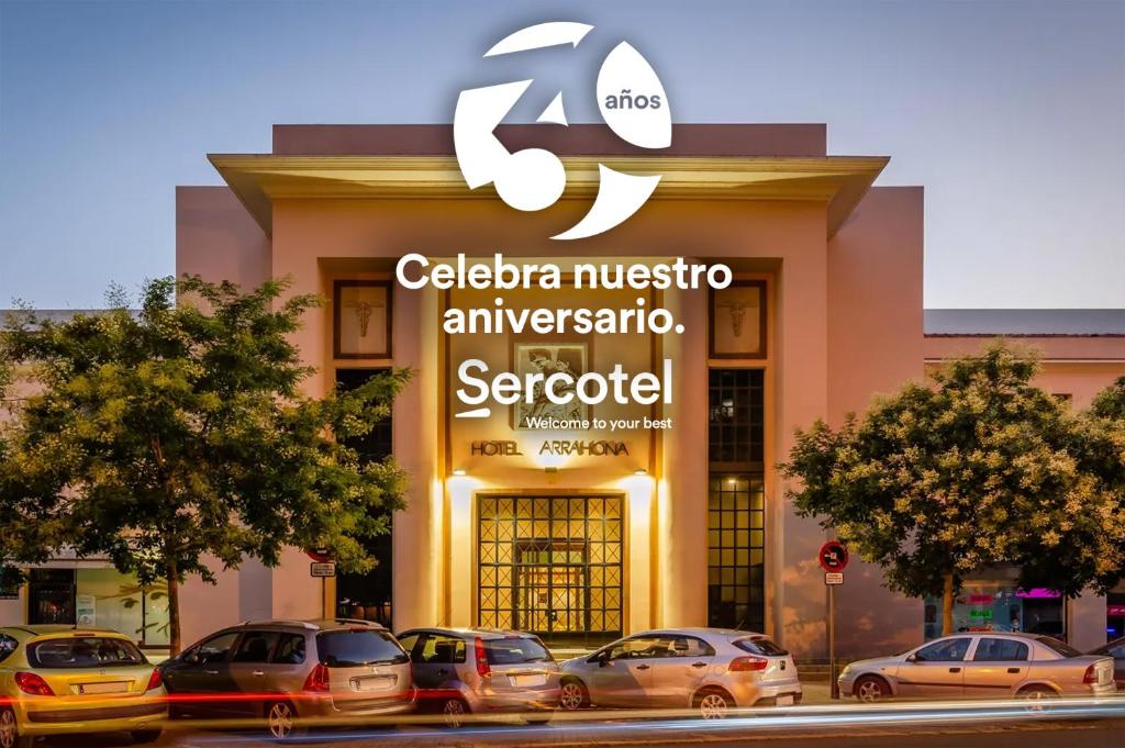 萨瓦德尔Sercotel Arrahona Sabadell的前面有汽车停放的建筑