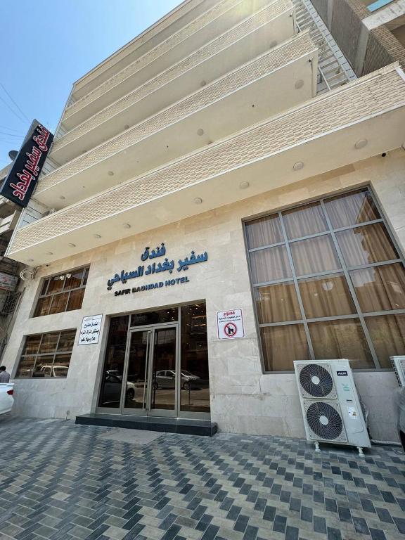 巴格达SAFIR BAGHDAD HoTEL的正面有标志的建筑物