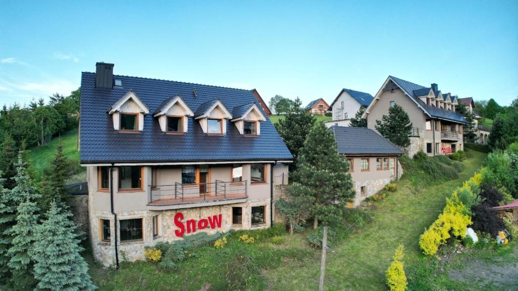 杜什尼基-兹德鲁伊Apartamenty SnowHouse的山坡上一座蓝色屋顶的房子