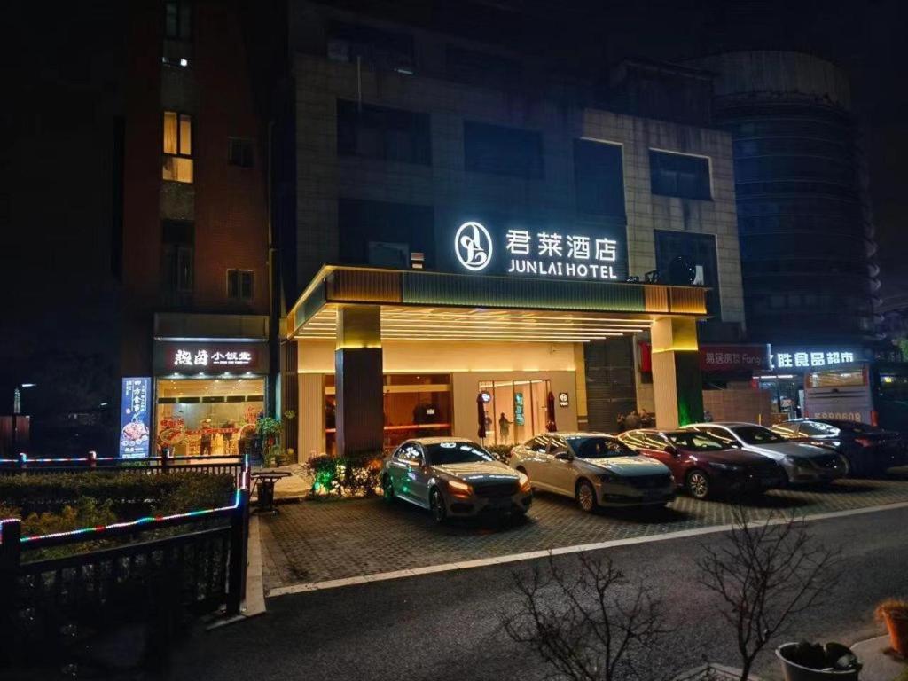 上海Junlai Hotel Pudong Airport Shanghai的停车场,停车场停在大楼前