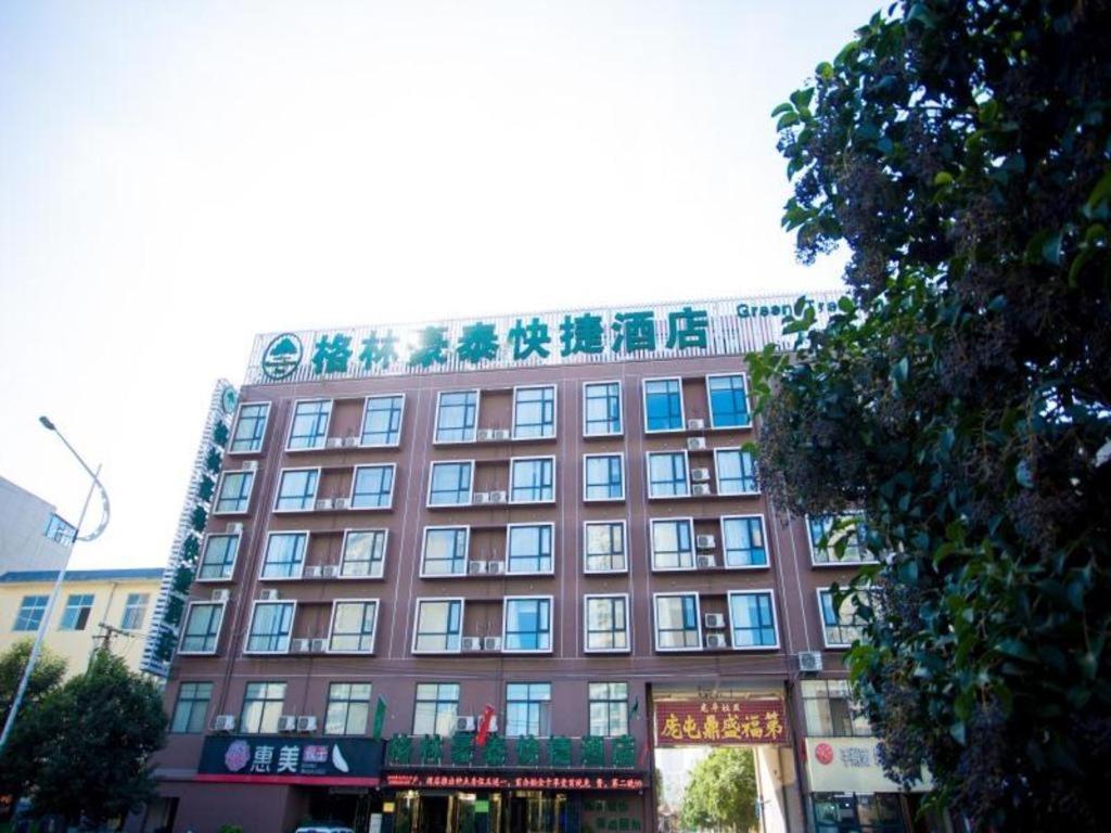 洛阳GreenTree Inn Luoyang Zhongzheng Street Express Hotel的一座大型的棕色建筑,有很多窗户