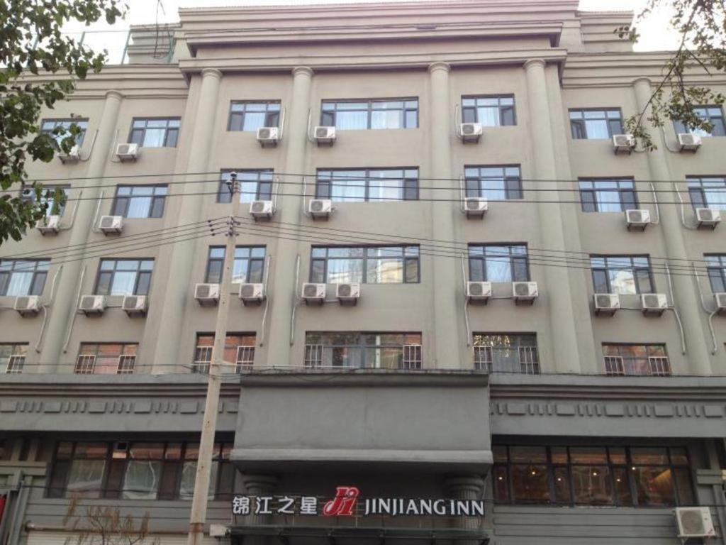 通化Jinjiang Inn Tonghua Shengli Road Branch的一座大型建筑的侧面设有窗户