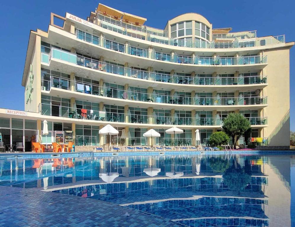 阳光海滩朱莉娅家庭公寓式酒店的大楼前设有游泳池的酒店