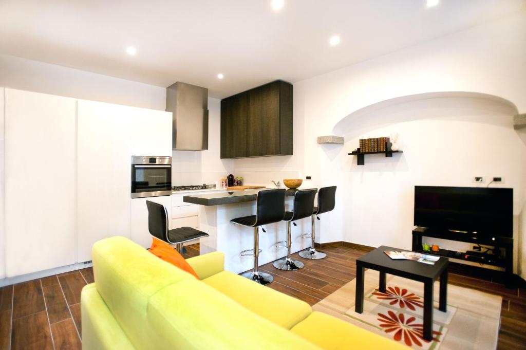大圣玛丽亚Appartamento Melissa的一间带黄色沙发的客厅和一间厨房