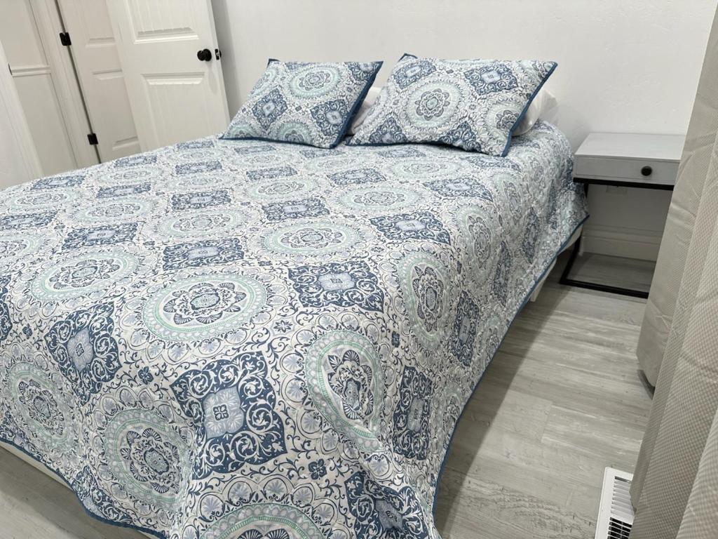 普罗沃5 bedroom house to share with your family and friends的一张带蓝色和白色毯子及枕头的床