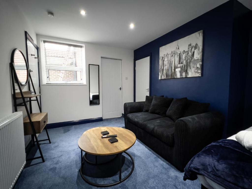 KillingworthNewly Refurbished 6 Person En-suite Apartment Tyne & Wear Newcastle Upon Tyne的客厅配有沙发和桌子