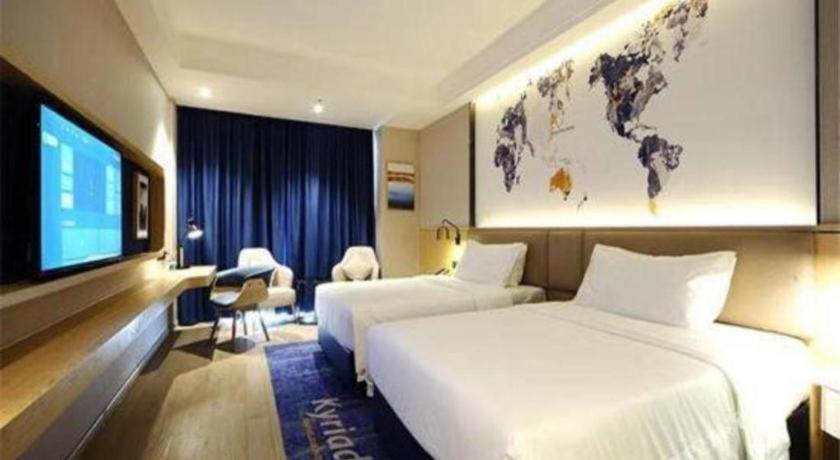 湘阴Kyriad Marvelous Hotel Xiangyin Bus Station的酒店客房设有两张床和一台平面电视。