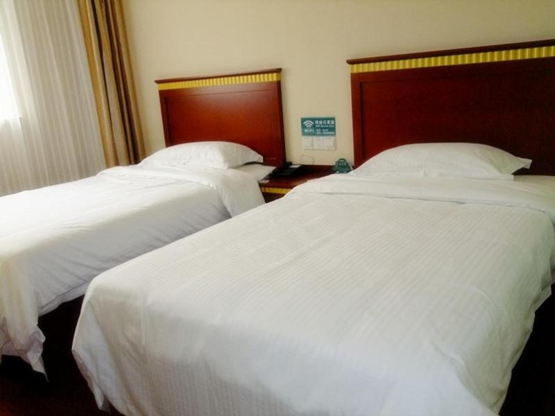 合肥格林豪泰安徽省合肥市汴河路园上园快捷酒店的配有白色床单的酒店客房内的两张床