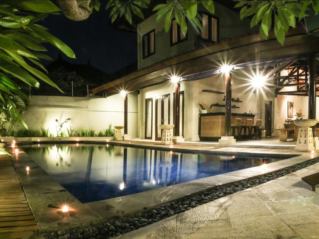 沙努尔琳达沙努尔别墅的夜间在房子前面的游泳池