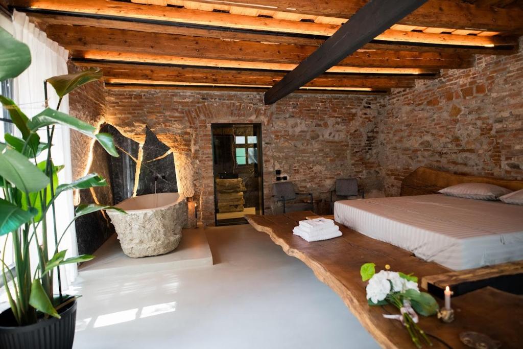 锡比乌World Studio Sibiu的卧室配有砖墙内的床铺