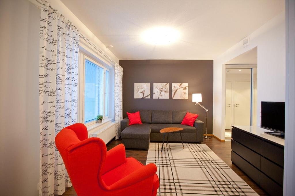 罗瓦涅米罗瓦涅米家世界公寓的客厅配有红色椅子和沙发