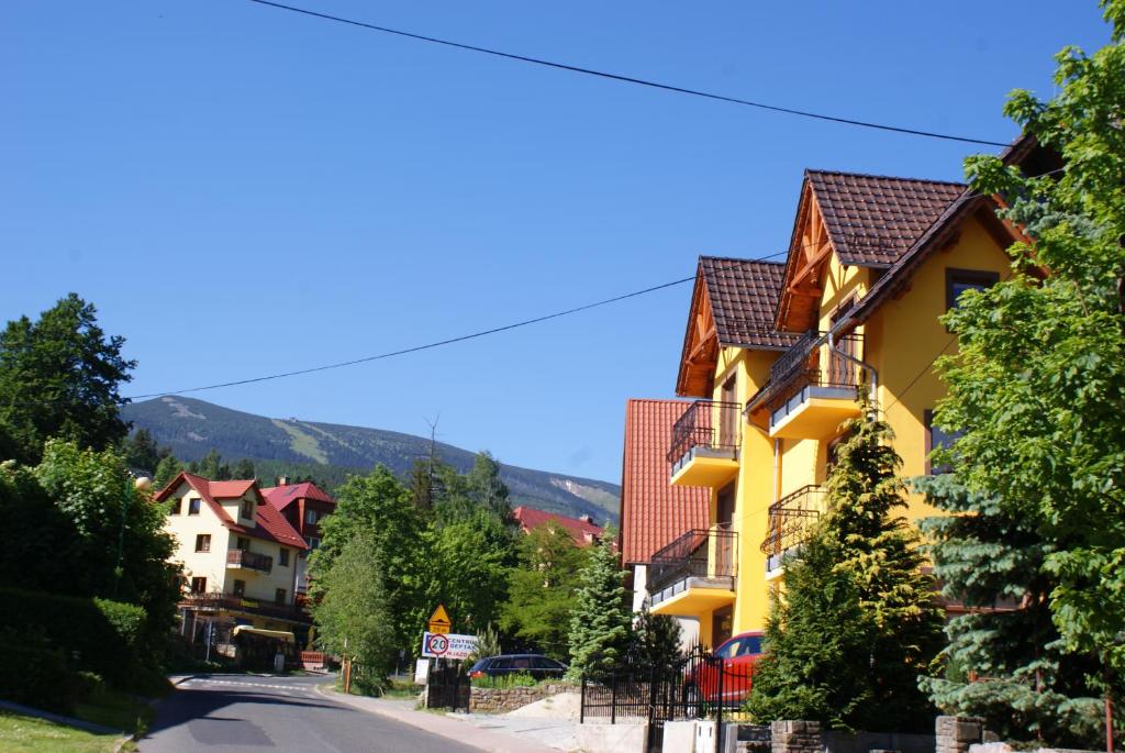 卡尔帕奇DARIA pokoje gościnne的街道边的黄色建筑