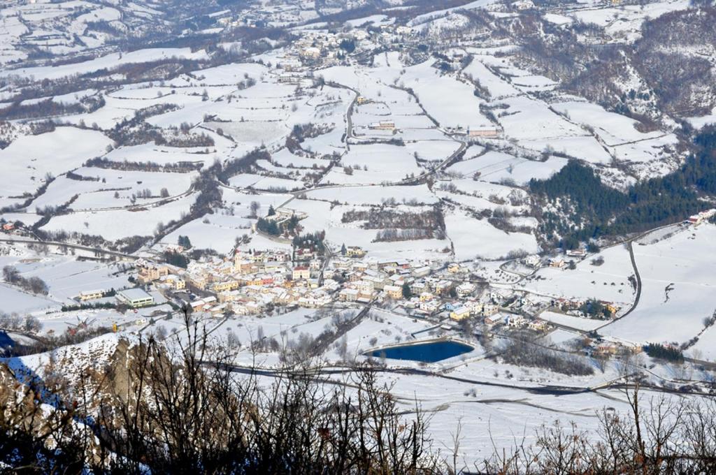 Cantalupo LigureTana Degli Orsi的雪中小镇的空中景色
