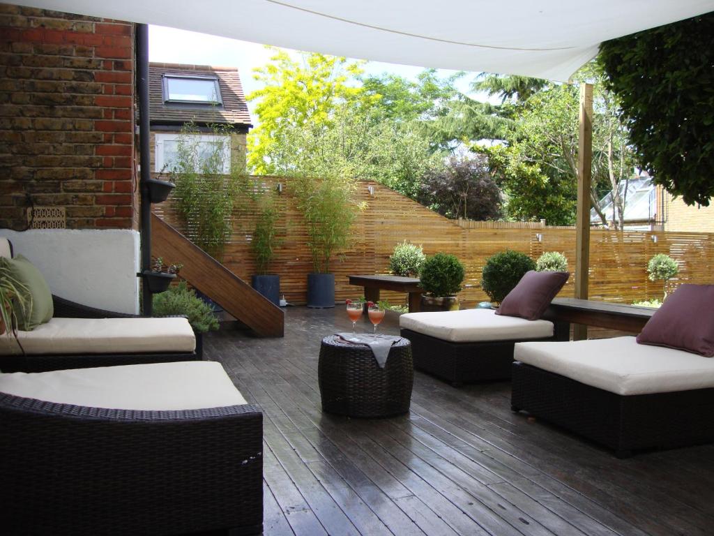 伦敦伦敦家庭花园旅馆的天井配有两张沙发和一张桌子