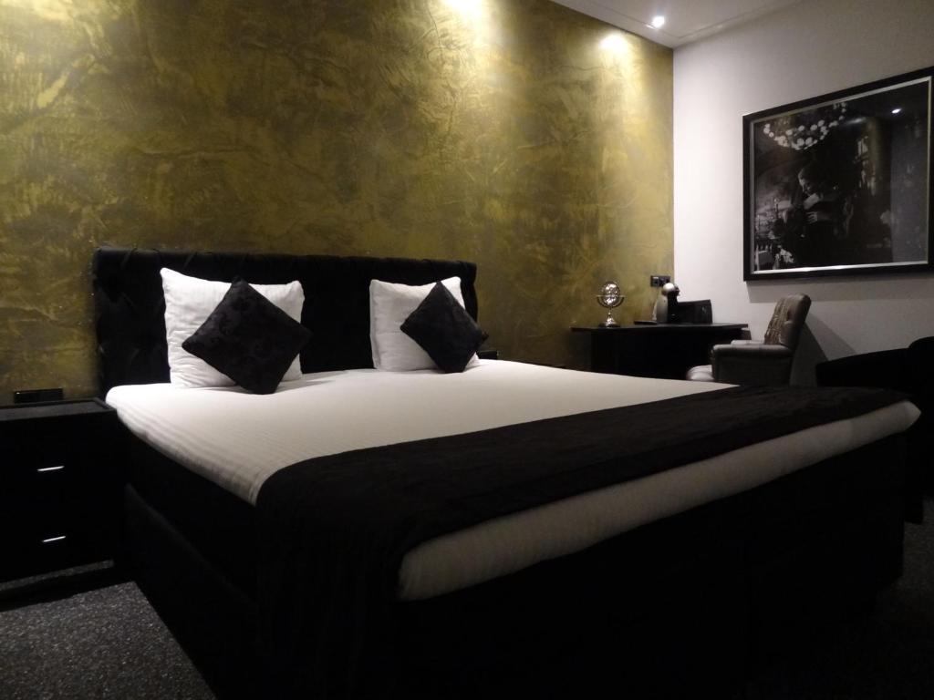 阿姆斯特丹萨拉精品酒店的卧室配有一张带白色床单和枕头的大床。