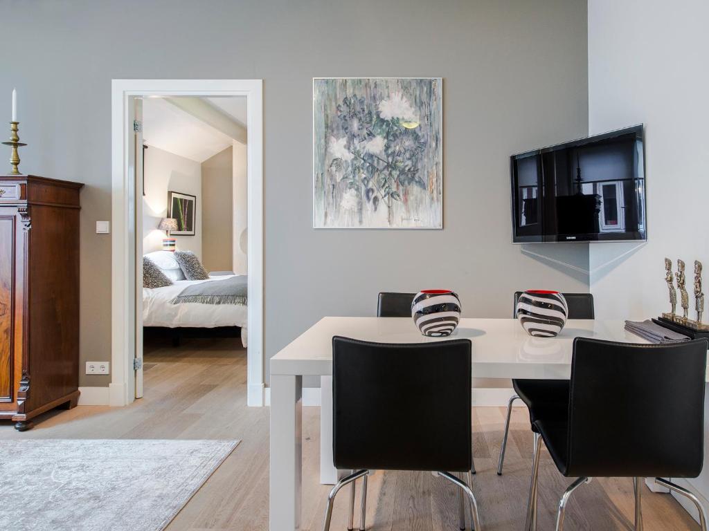 阿姆斯特丹阿姆斯特丹棕榈公寓酒店的客厅配有白色的桌子和椅子