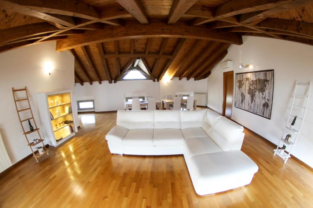 贝加莫多尼采蒂皇家住宿加早餐旅馆的客厅配有白色家具和木制天花板