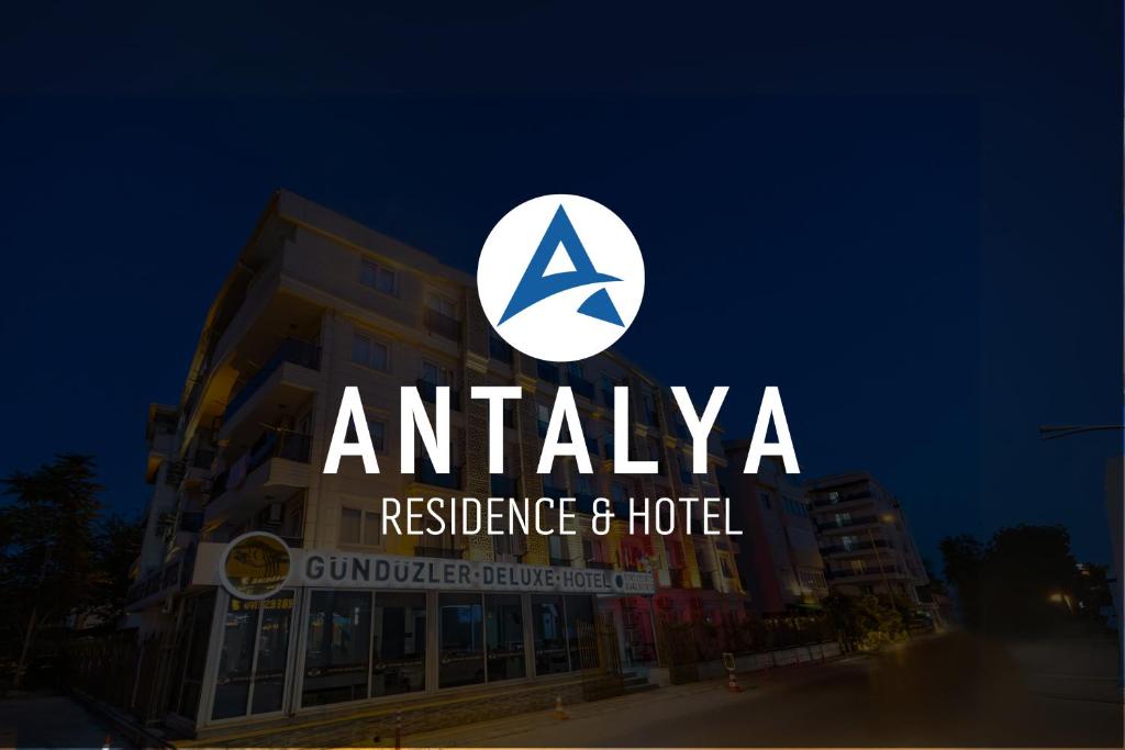 安塔利亚Antalya Residence Hotel的大楼顶部的Anania住宅和酒店标志