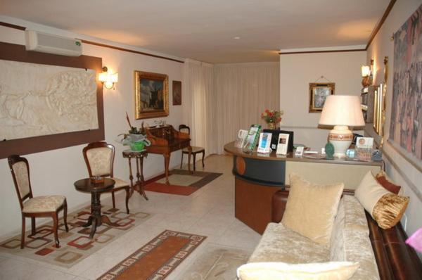 卡诺萨迪普利亚肯纽西恩酒店的客厅配有沙发和桌椅