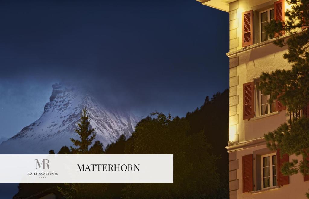 采尔马特蒙特罗莎精品酒店的天上的山,有建筑