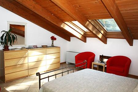 特尔尼毕左妮居住酒店的一间卧室配有一张床和两张红色椅子
