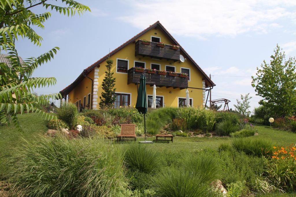 MakoleHostel Strug的黄色的房子,前面有一个花园