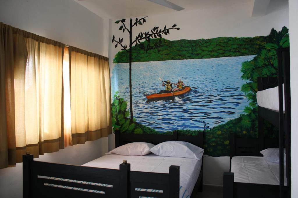 图斯特拉古铁雷斯Hotel Calle8的一间卧室,画着一张独木舟上的两人画