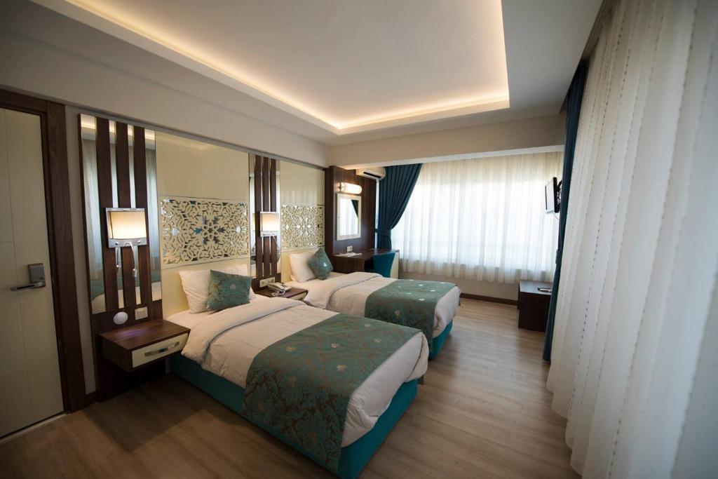 Rest Inn Aydın Hotel客房内的一张或多张床位