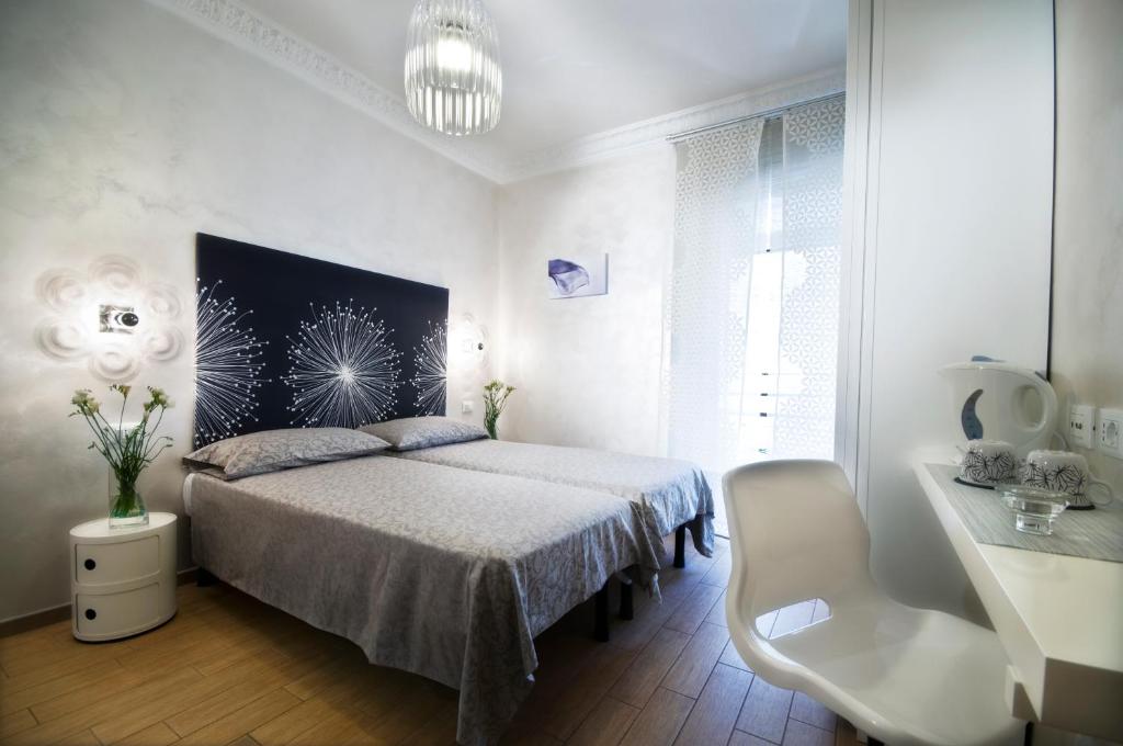 罗马多莫斯戴安娜酒店的白色卧室,配有床和白色椅子