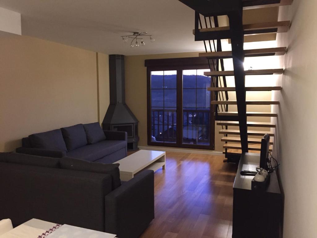 塞尔瓦堡Residencial Ribes- Massana的客厅设有蓝色的沙发和壁炉