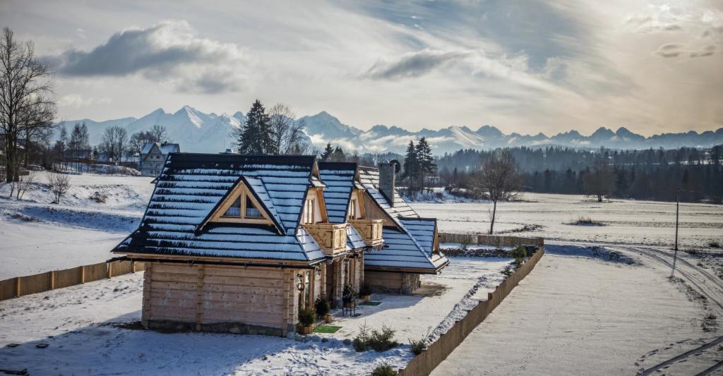 恰萨纳格拉Domki nad Białką的雪中带屋顶的小房子