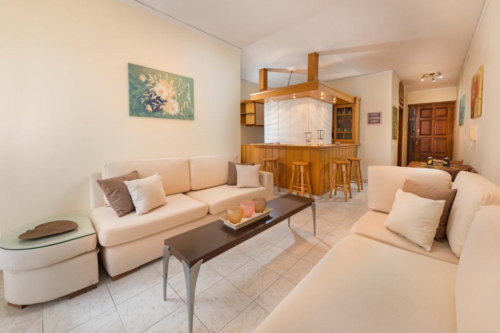 伊利索斯梦想假期公寓的客厅配有沙发和桌子