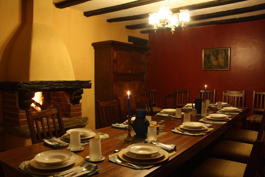 Hacienda ZuletaHacienda La Merced Baja的一间带长桌和壁炉的用餐室