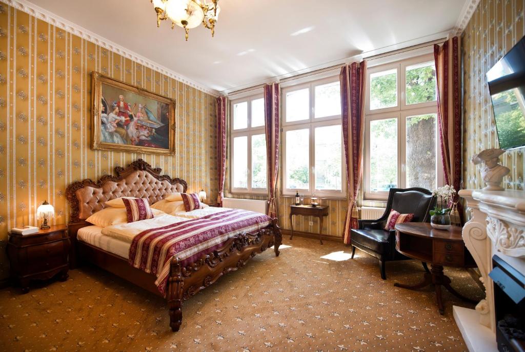 波茨坦弗里茨别墅宾馆的一间卧室配有一张床、一把椅子和窗户。