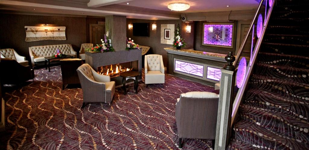 库克斯敦格林韦尔酒店 的客房设有壁炉、椅子和楼梯。